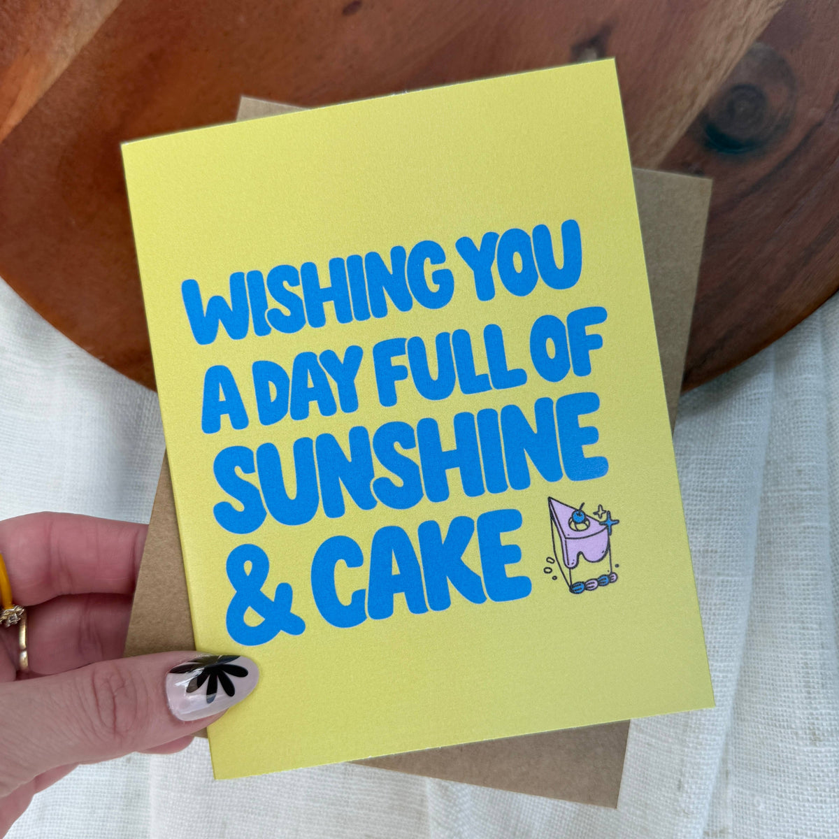 "Wishing you a day full of sunshine and cake" Birthday Card