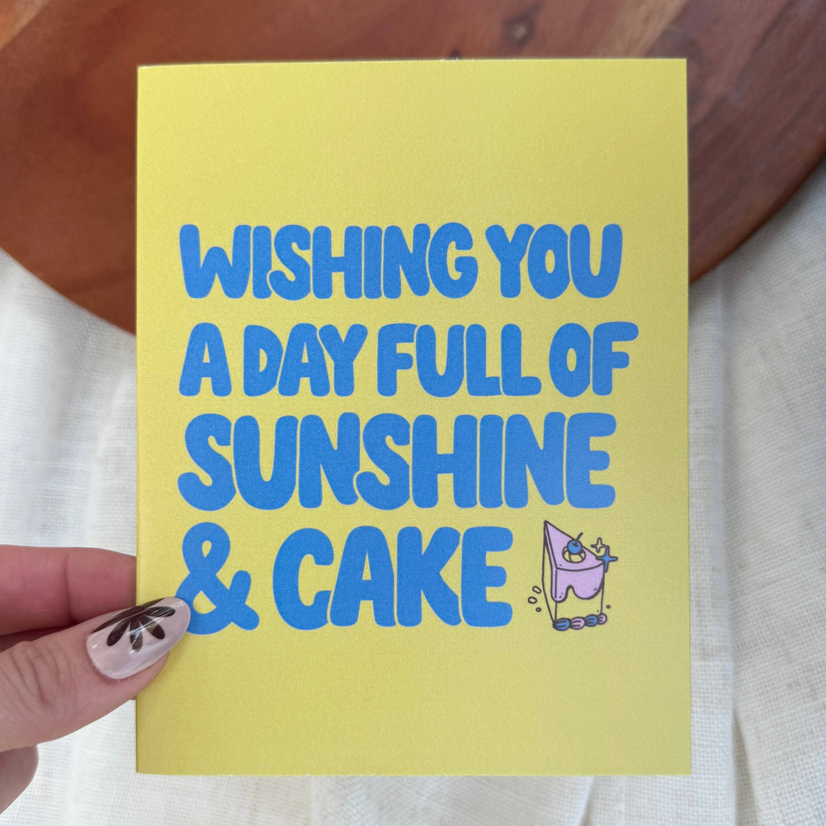"Wishing you a day full of sunshine and cake" Birthday Card